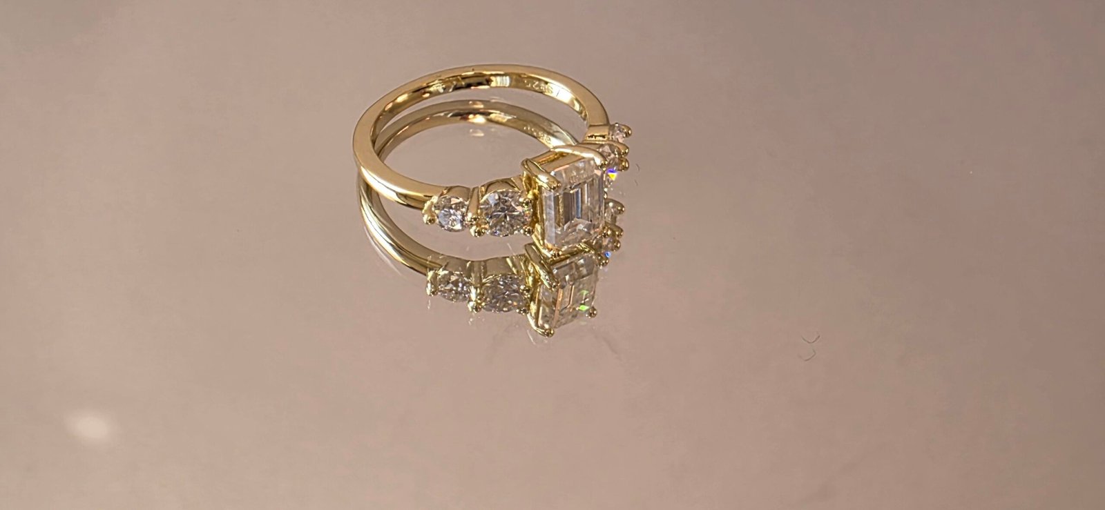 2025/08/1000249457-scaled.jpg Moissanite Five-Stone Ring – Emerald Center, 14K Light Gold Plated 925 Sterling Silver - Image 1