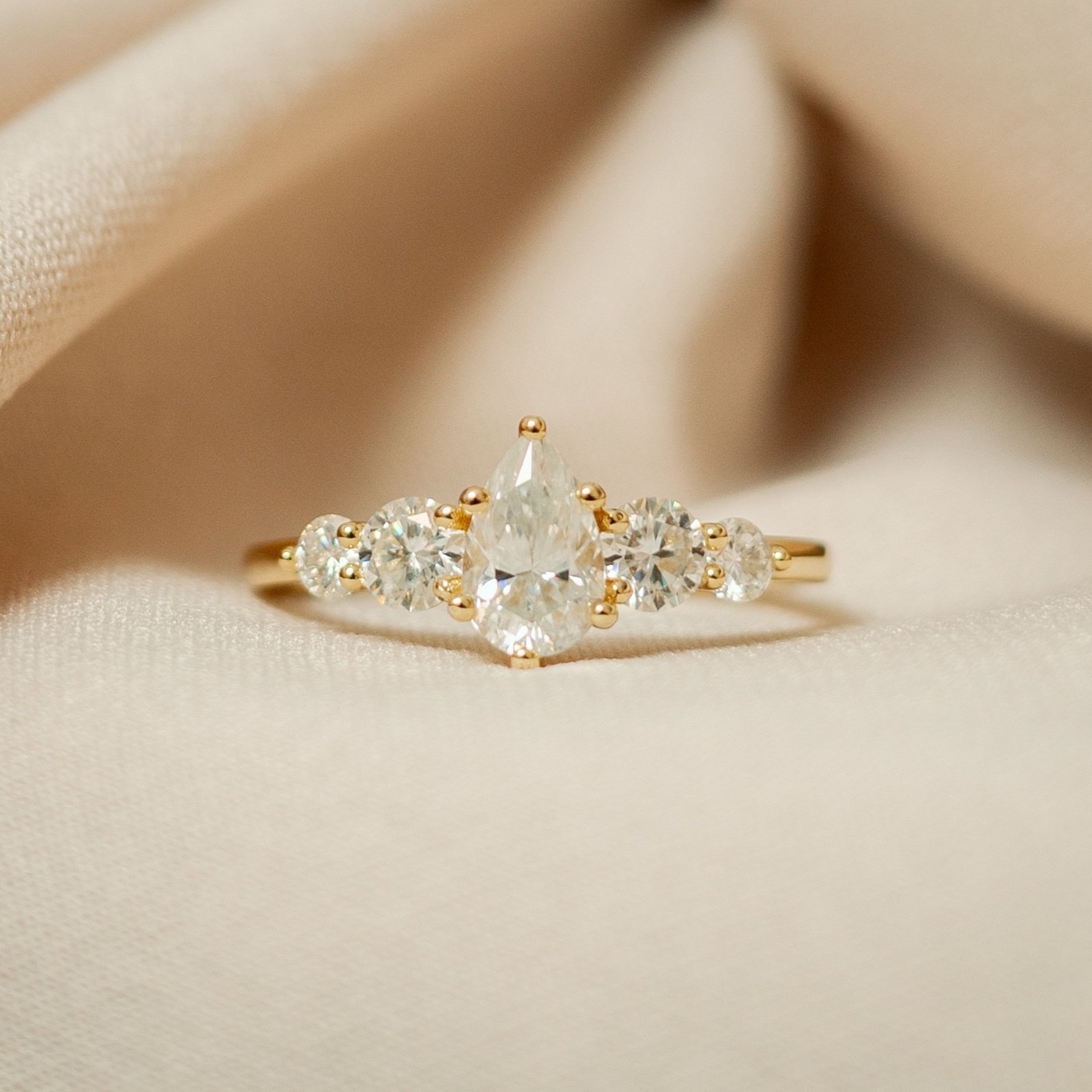 2025/08/1000315095.jpg Moissanite Five-Stone Ring – Pear Center, 14K Light Gold Plated 925 Sterling Silver - Image 1