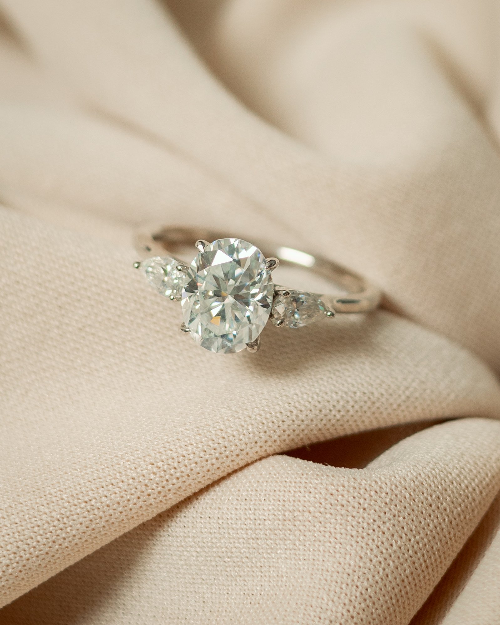 _L5A8597 Moissanite Three-Stone Ring – Oval Center, Rhodium-Plated 925 Sterling Silver - Image 1